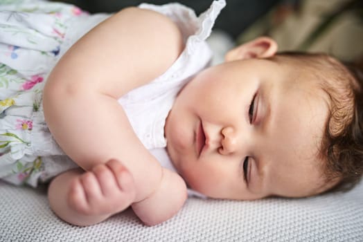 Sweet dreams, little one. an adorable baby girl sleeping on the bed at home