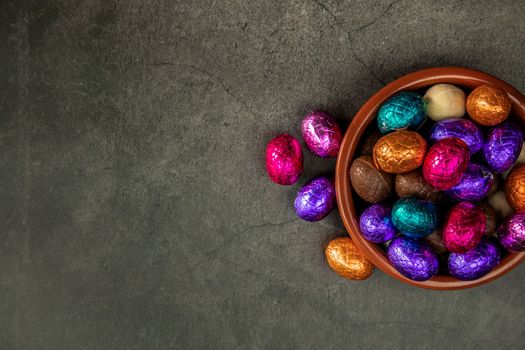 Sweet chocolate easter eggs and candies on grey table, flat lay with copy space, Happy Easter concept on concrete background texture candy concept