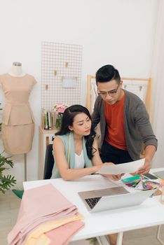 Two fashion designers working together on a desk