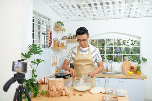 Food blogger recording video in his workplace