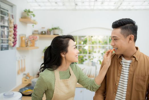 Attractive couple is cooking on kitchen.