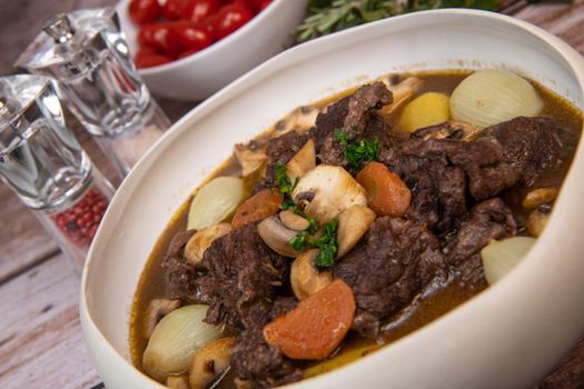 Beef bourguignon recipe, beef stew with wine sauce and vegetables. High quality photo