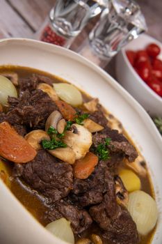 Beef bourguignon recipe, beef stew with wine sauce and vegetables. High quality photo