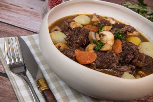 Beef bourguignon recipe, beef stew with wine sauce and vegetables. High quality photo