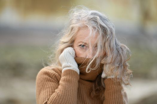 Portrait of a sixty-year-old woman with a grey hair