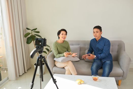 Asian couple blogger enjoy communication lives with camera house background concept