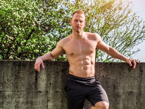 Handsome Muscular Shirtless Hunk Man Outdoor in Country Standing on Grass. Showing Healthy Muscle Body While Looking away