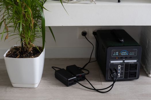 Charging station for phone, tablet, laptop and other gadgets when there is no light during blackout. Generator power bank battery in the absence of electricity. Charge electric rechargeable battery.