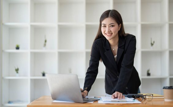 Beautiful Asian businesswoman crossed arms at the office looking at the camera...