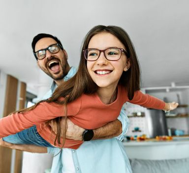 Family father and daughter having fun playing at home