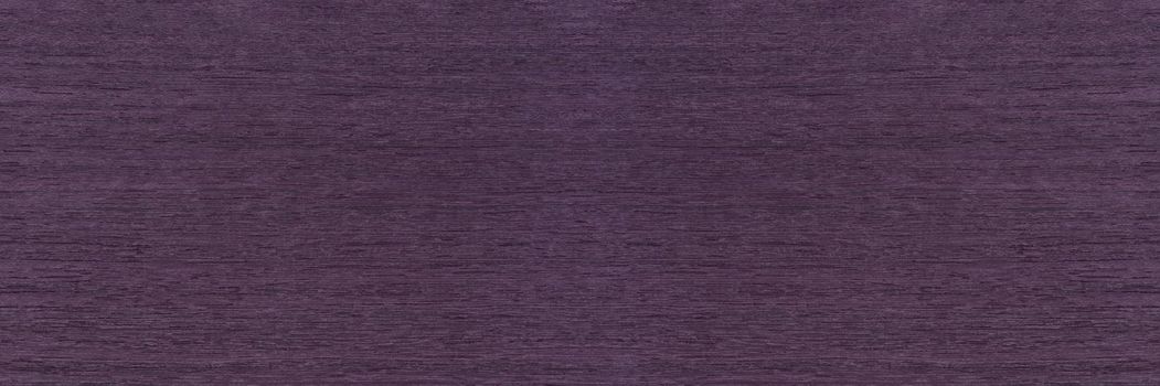 Wood texture with purple tint, koto wood texture. Veneer of rare exotic koto wood for the production of exclusive furniture.