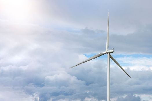 Green wind energy. Windmills for the production of renewable electricity. Windmills in the field, produce electricity on a sunny summer day.