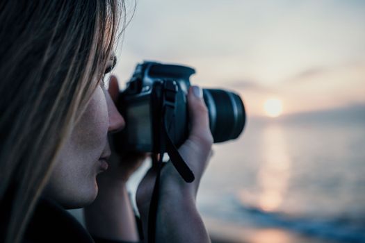 Woman travel sea. Happy tourist taking picture outdoors for memories. Woman traveler looks at the edge of the cliff on the sea bay of mountains, sharing travel adventure journey.