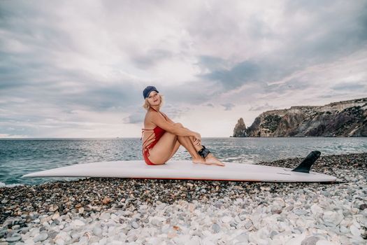 young woman in stylish bikini lying on seashore, closeup. Holiday, vacation and recreational concept.