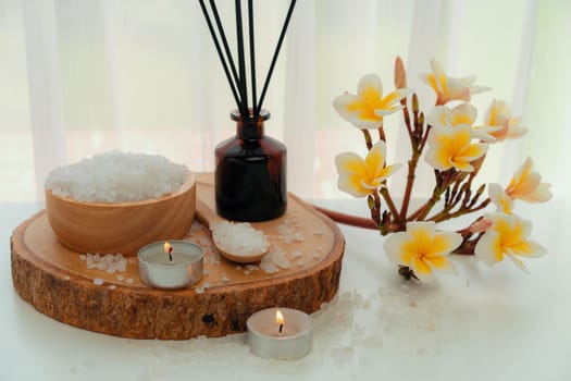 Spa accessory composition set in day spa hotel , beauty wellness center . Spa product are placed in luxury spa resort room , ready for massage therapy from professional service .