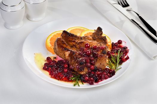  Fried pork chops served with cranberry sauce with orange and rosemary. They are elegant for a lunch or dinner party.