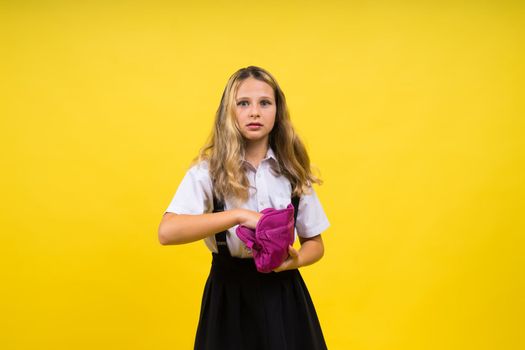 Happy schoolgirl with colored pencils and pencil case in hand
