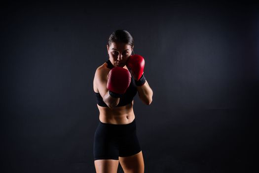 Woman do a high kick, tae-bo. Athletic fit female with perfect body kick air, punching with legs
