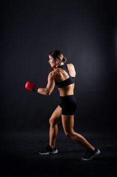 Woman do a high kick, tae-bo. Athletic fit female with perfect body kick air, punching with legs