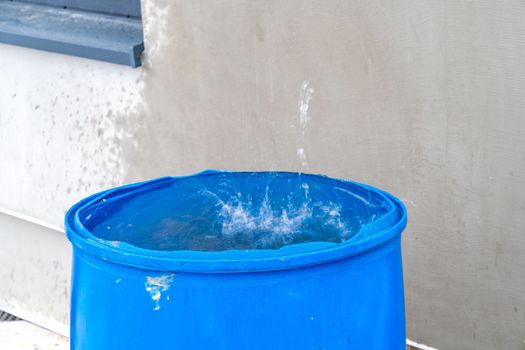rainwater in a barrel in front of the house.