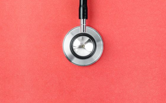 Close up Stethoscope on red background with empty space for your text.