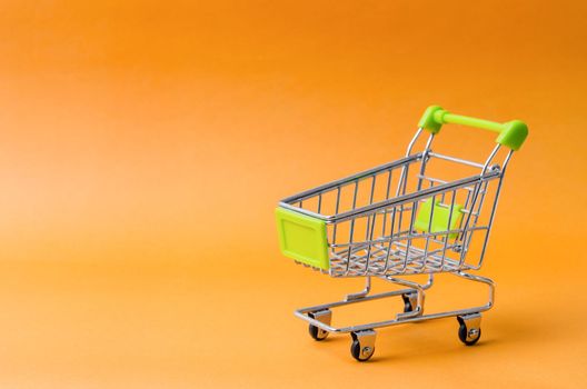 Empty Shopping Cart on a isolated yellow background with copy space.