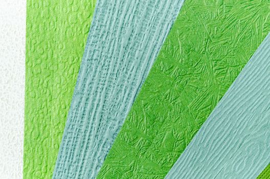 color swatch of green paper texture made from recycled paper is used by designers to define the right colors for a project.