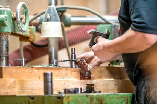 replacement of knives on a milling machine in a joinery. High quality photo
