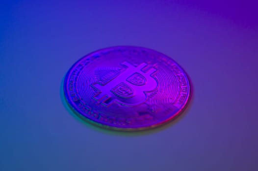 Crypto currency golden-pink coin with bitcoin symbol on isolated on black background. Bitcoin Coin on colored background. Bitcoin cryptocurrency. Cryptocurrency Coin Concept. single golden valuable