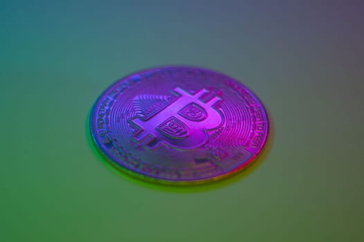 Crypto currency golden-pink coin with bitcoin symbol on isolated on black background. Bitcoin Coin on colored background. Bitcoin cryptocurrency. Cryptocurrency Coin Concept. single golden valuable