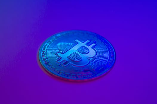 Crypto currency blue coin with bitcoin symbol on isolated on black background. Bitcoin Coin on colored background. Bitcoin cryptocurrency. Cryptocurrency Coin Concept. single golden valuable