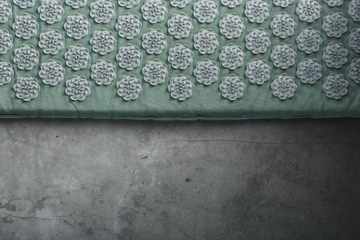 Massage mat with prickly spikes Kuznetsov applicator top view. On a gray background with free space