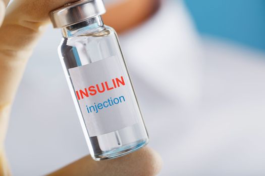 An ampoule of insulin for the treatment of diabetes in the doctor's hand close-up