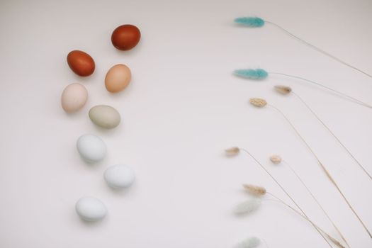 Chicken eggs of natural shades and colors a white background. Healthy organic food, natural farmer's products concept. Happy Easter background. Selective focus.