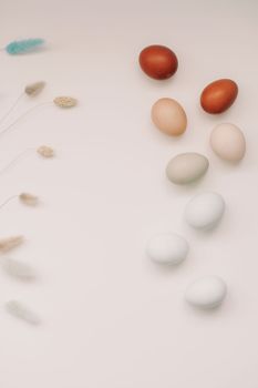 Chicken eggs of natural shades and colors a white background. Healthy organic food, natural farmer's products concept. Happy Easter background. Selective focus.