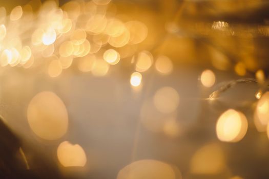 abstract shiny gold background. blured bokeh glowing golden background for design with copyspace