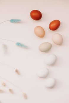 Chicken eggs of natural shades and colors a white background. Healthy organic food, natural farmer's products concept. Happy Easter background. Selective focus.