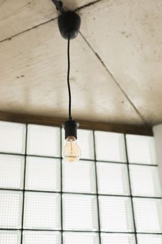 vintage light bulb hanging from ceiling for decoration in living room.