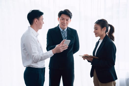 Mentor, manager advice younger colleagues in workplace. Businesspeople discussing or planning financial project strategy, talking together for harmony and strong teamwork in office concept.