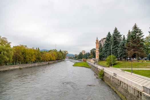 Terek river in Vladikavkaz. Urban landscape. Church and modern buildings