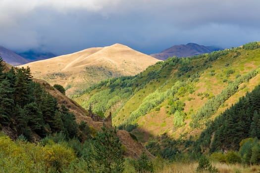 Highlands of North Ossetia. Mountains of the Caucasus. High mountains in the rays of the setting sun