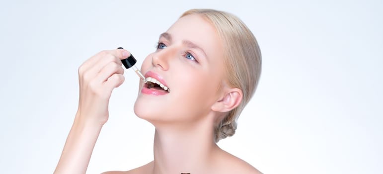 Closeup personable portrait of beautiful woman applying essential oil bottle for skincare product. Cannabis extracted CBD oil dropper for treatment and cannabinoids concept in isolated background.