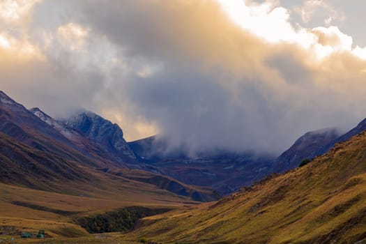 Highlands of North Ossetia. Mountains of the Caucasus. High mountains in the rays of the setting sun