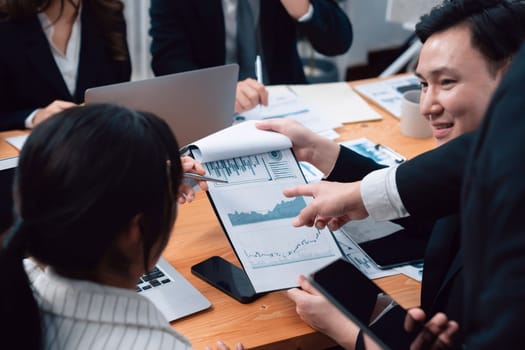 Business team of financial data analysis meeting with business intelligence, report paper and dashboard on laptop for marketing strategy. Business people working together to promote harmony in office.