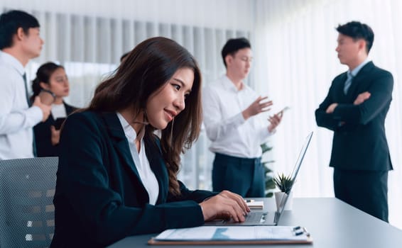 Focus portrait of female manger, businesswoman in the harmony meeting room with blurred of colleagues working together, analyzing financial paper report and dashboard data in background.