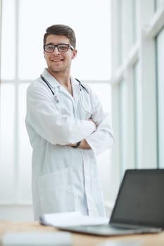 Portrait of young, doctor sitting in medical office