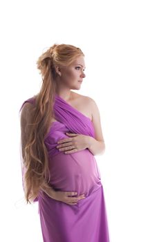 Young cheerful woman in pink fabric expect baby isolated