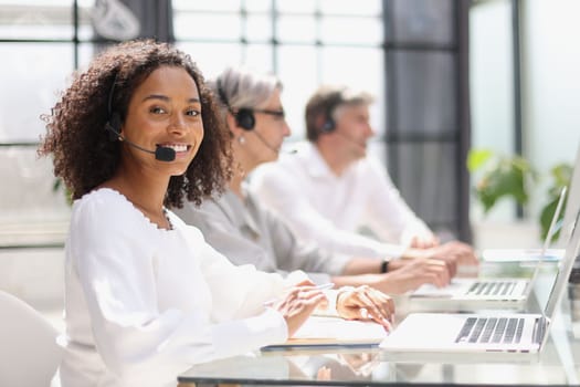 african american operator smiling in a call center.