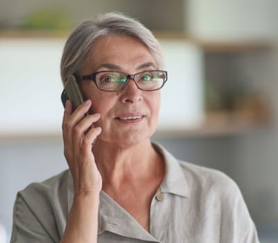 mature woman calling on the phone in the office.