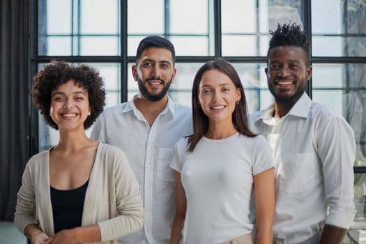 Portrait of successful creative business team looking at camera and smiling. Diverse business people standing together at startup.